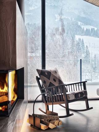 Rocking chair in front of a fireplace