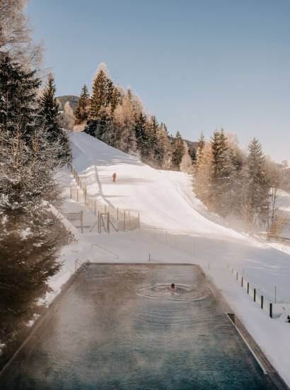 Outdoor pool overlooking ski slope in winter